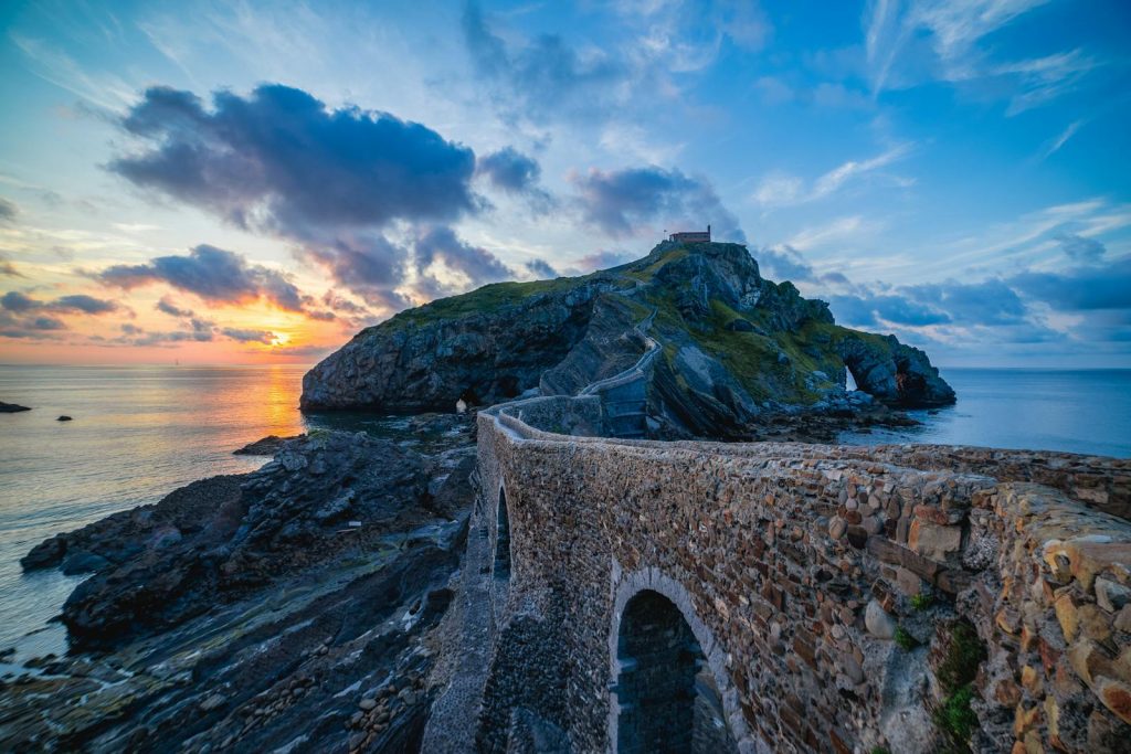 Stunning sunset view over the coastal pathway to Gaztelugatxe islet in Spain.